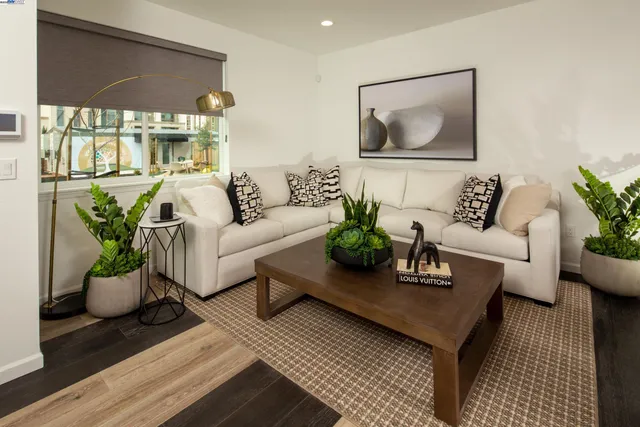 a living room with furniture potted plant and bathroom