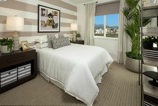a bedroom with a bed and a potted plant