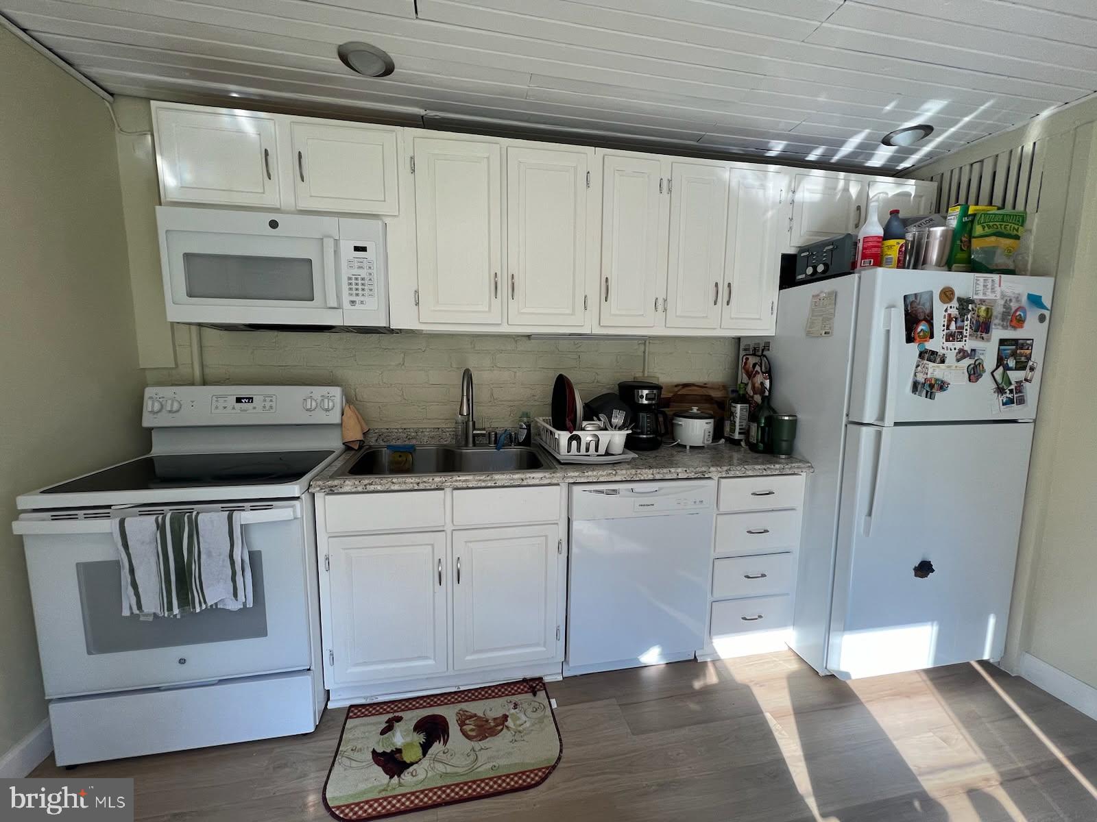 2022 Brown Road, Unit A Finksburg, MD 21048 - Photo 6 of 13 a kitchen with white cabinets and refrigerator