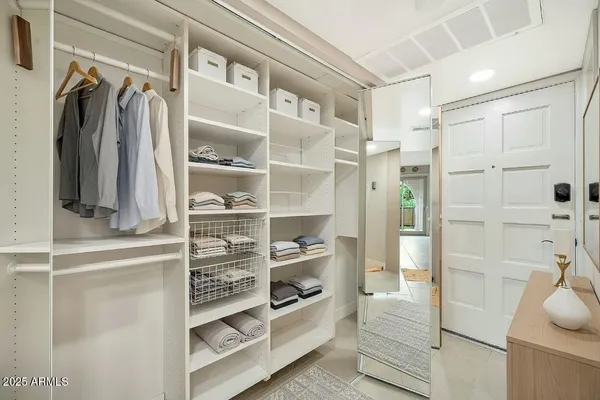 a view of walk in closet with empty racks
