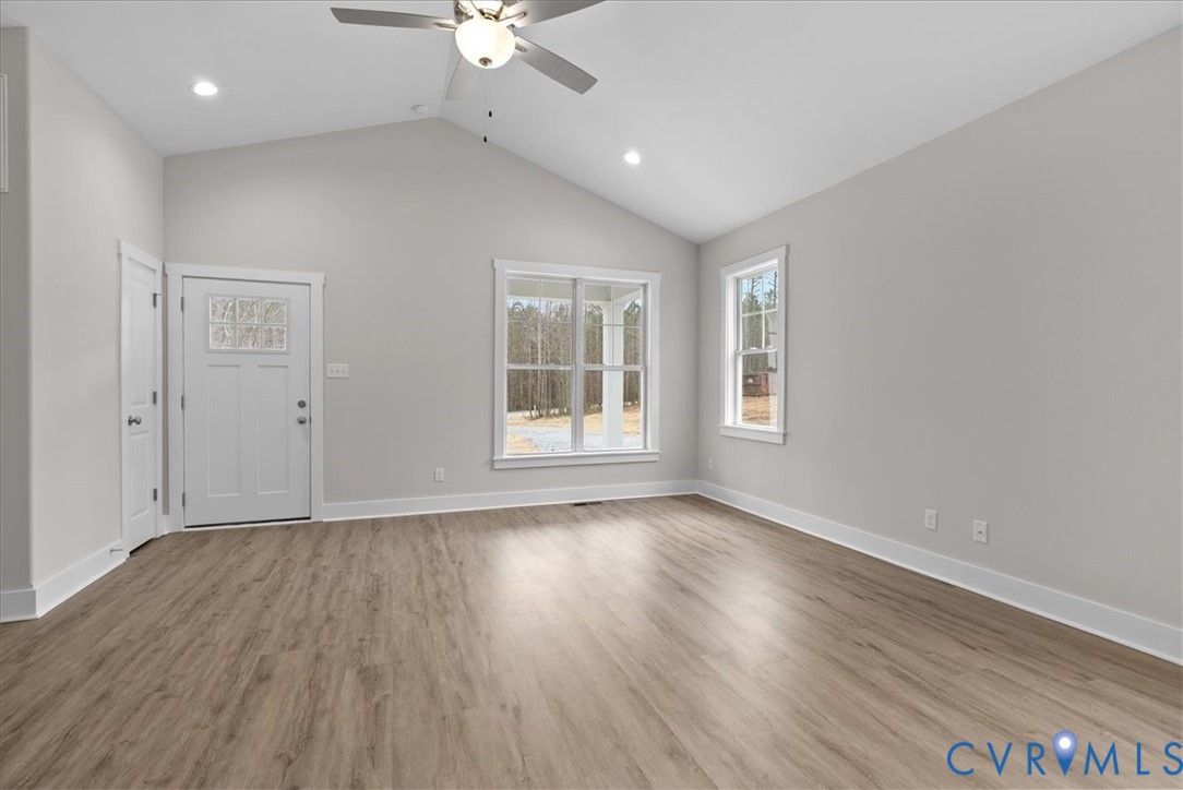 447 Raleigh Avenue South Hill, VA 23970 - Photo 25 of 31 an empty room with wooden floor chandelier fan and windows