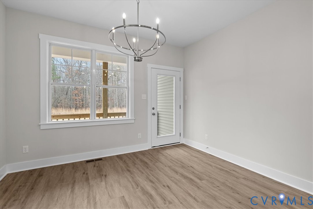 447 Raleigh Avenue South Hill, VA 23970 - Photo 3 of 31 a view of empty room with wooden floor and fan