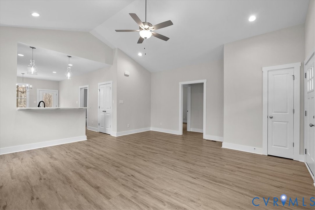 447 Raleigh Avenue South Hill, VA 23970 - Photo 4 of 31 a view of an empty room with wooden floor and a ceiling fan