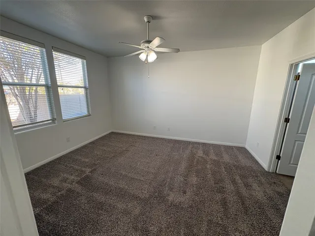 an empty room with windows and entrance