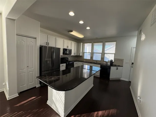 a kitchen with stainless steel appliances a sink stove and refrigerator