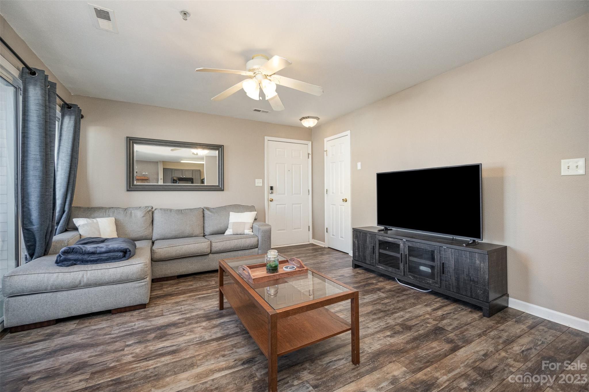 4006 Town Center Road Harrisburg, NC 28075 - Photo 5 of 19 a living room with furniture and a flat screen tv
