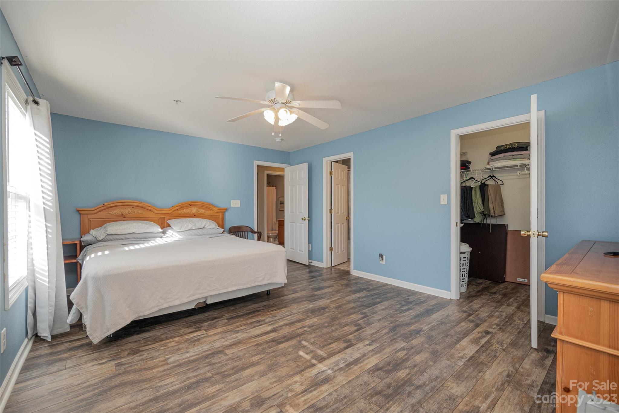 4006 Town Center Road Harrisburg, NC 28075 - Photo 10 of 19 a bedroom with a bed and a chandelier