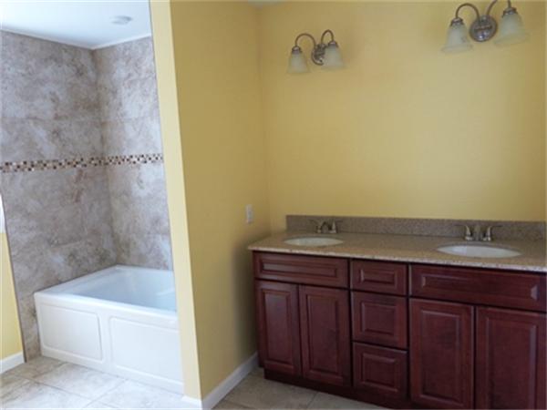 212 Mazarin Street Springfield, MA 01151 - Photo 12 of 22 a bathroom with a granite countertop sink and a bathtub