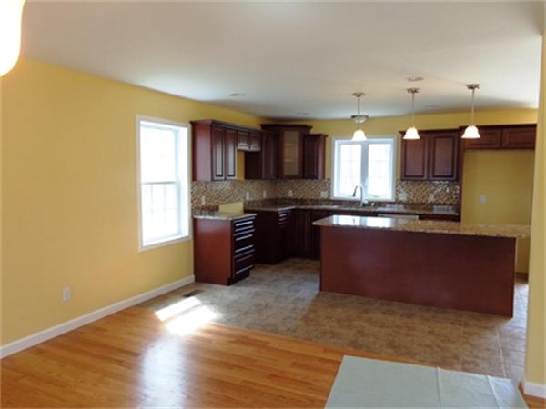 212 Mazarin Street Springfield, MA 01151 - Photo 2 of 22 a large kitchen with stainless steel appliances granite countertop a stove a sink and a microwave