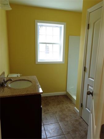 212 Mazarin Street Springfield, MA 01151 - Photo 6 of 22 a bathroom with a granite countertop sink and a mirror