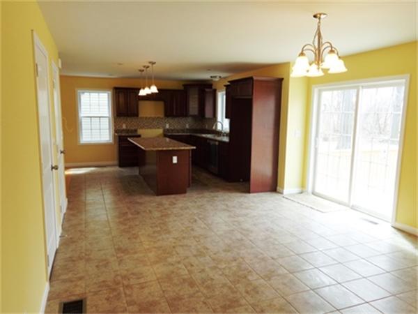 212 Mazarin Street Springfield, MA 01151 - Photo 7 of 22 a large kitchen with a refrigerator a stove top oven a sink and dishwasher