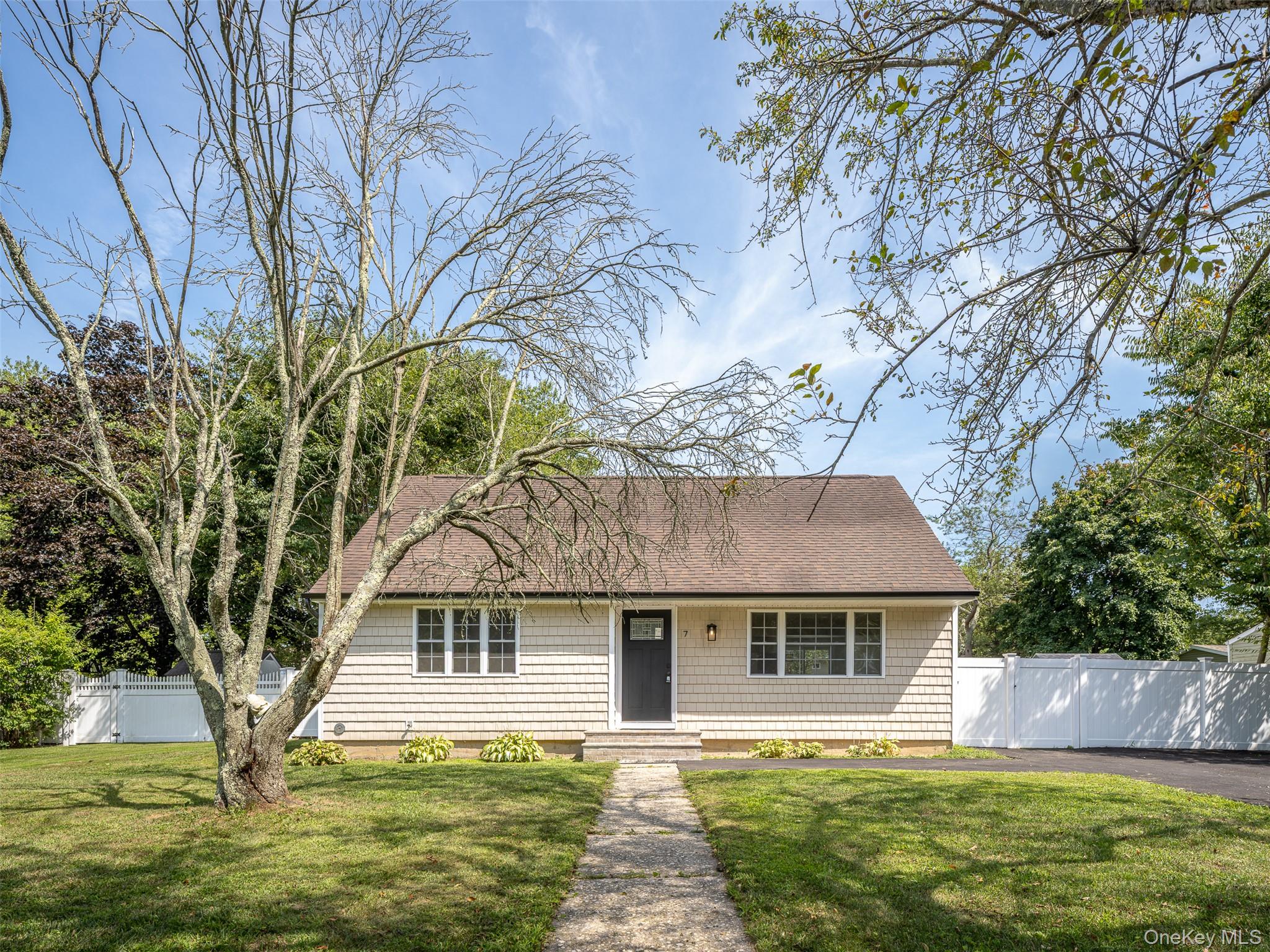 7 Highview Lane Ridge, NY 11961 - Photo 1 of 1 a front view of house with yard and green space