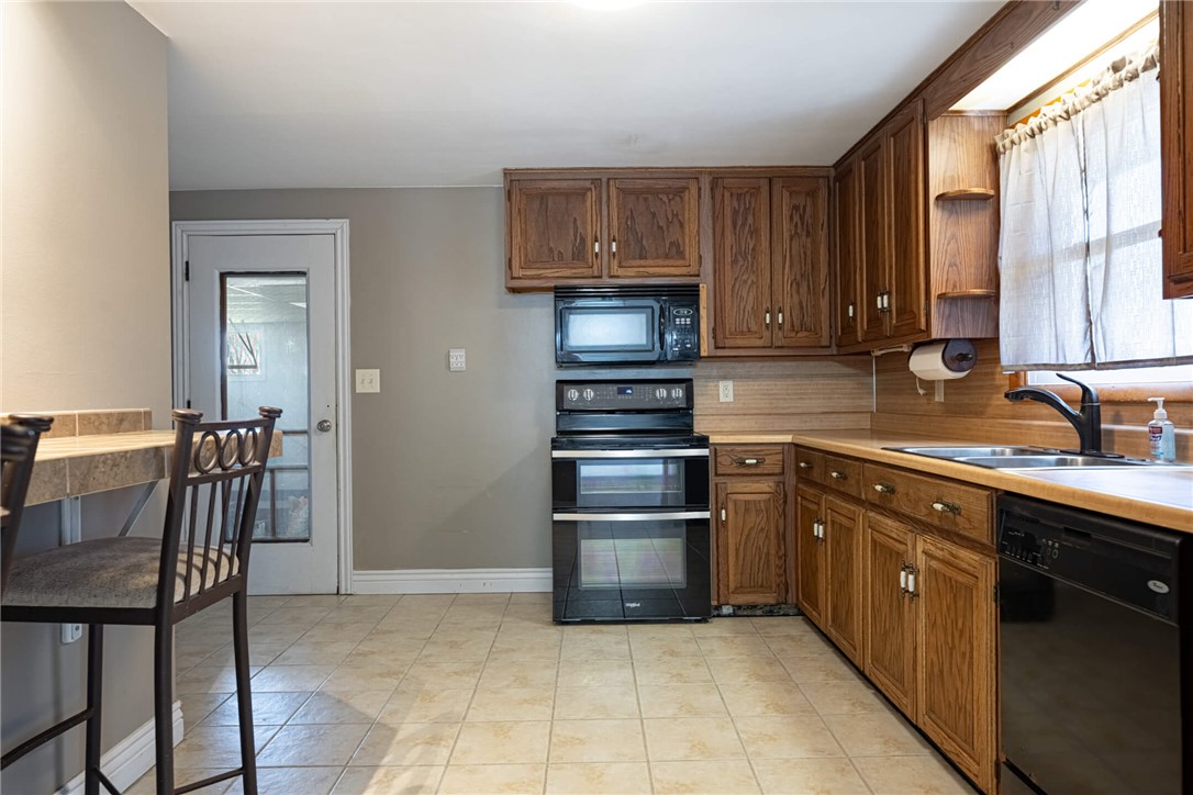5235 West Ridgewood Road Springfield, OH 45503 - Photo 7 of 32 This functional kitchen provides a practical and inviting space for daily living and culinary activities.