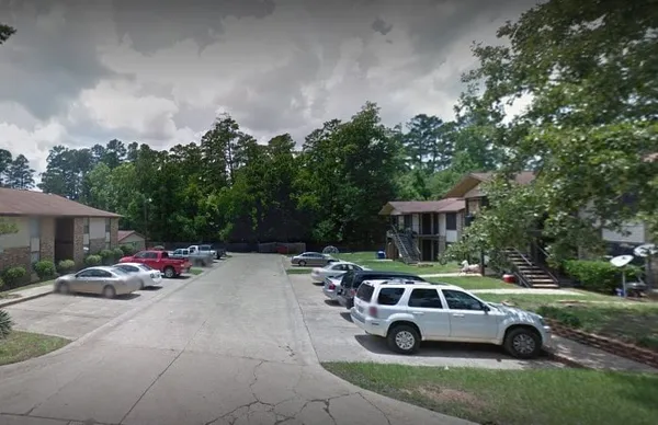 a front view of a house with cars parked