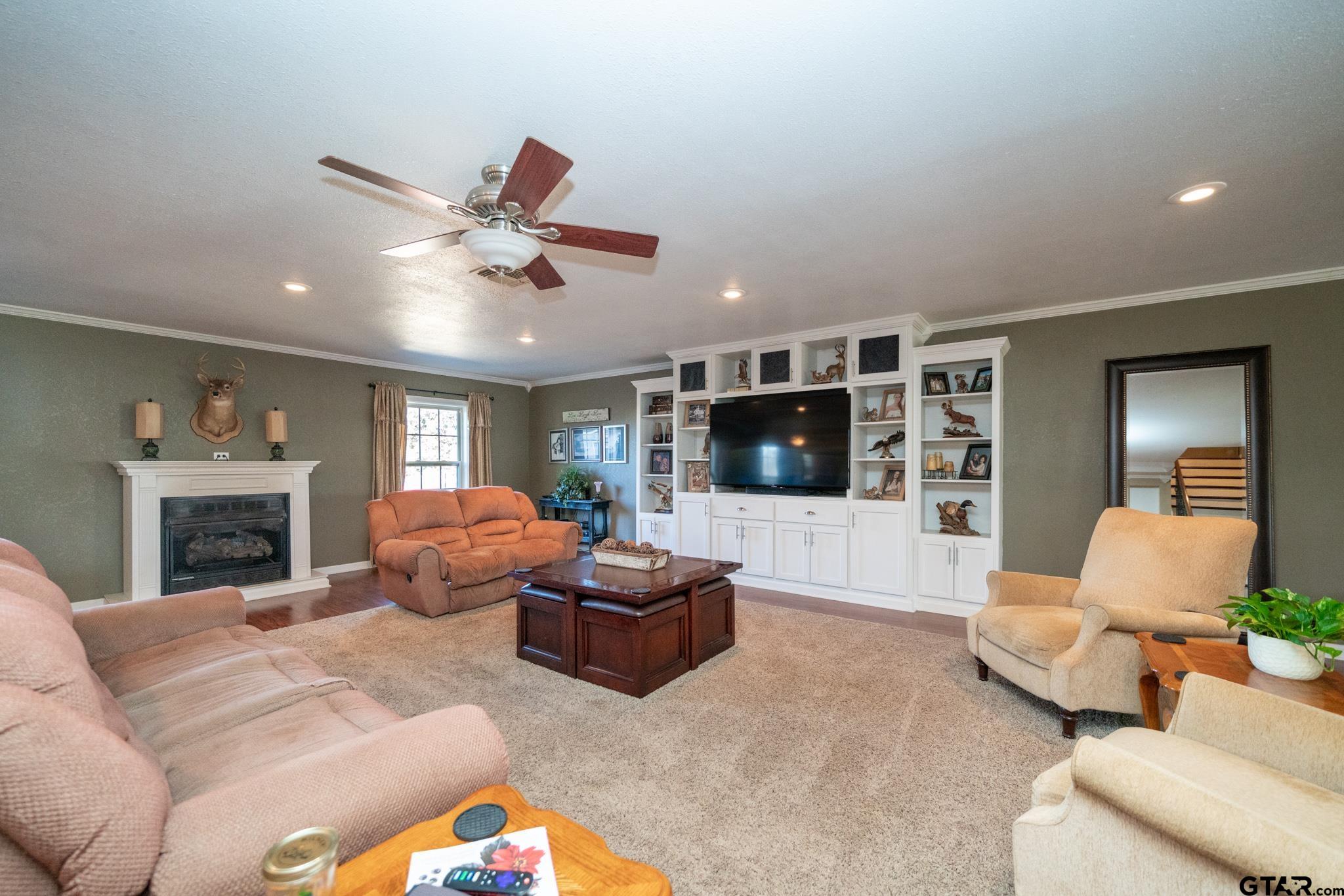 4538 West Loop 281 Longview, TX 75604 - Photo 24 of 45 a living room with furniture a flat screen tv and a fireplace