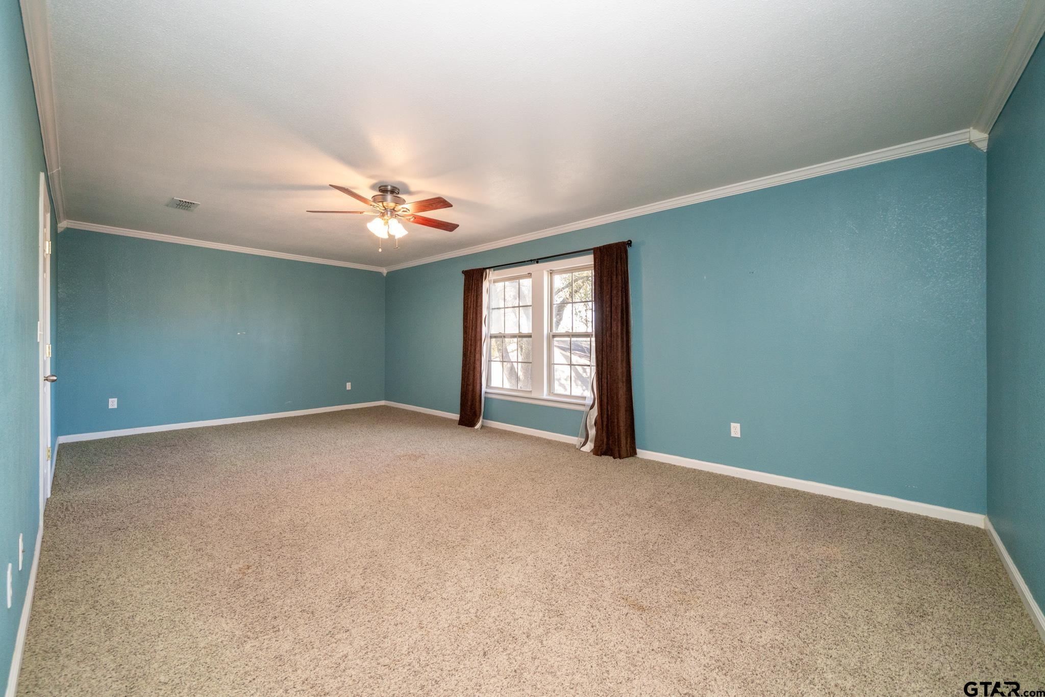 4538 West Loop 281 Longview, TX 75604 - Photo 43 of 45 an empty room with windows and ceiling fan