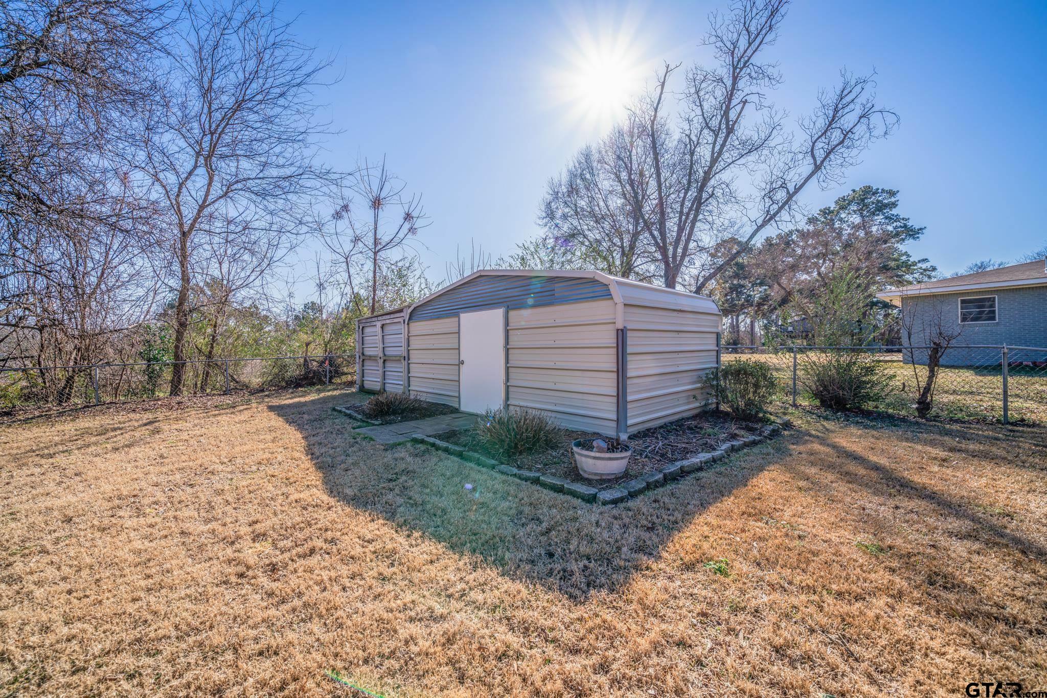 4538 West Loop 281 Longview, TX 75604 - Photo 9 of 45 a view of a backyard with wooden fence