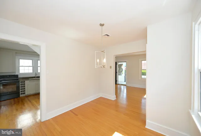 a kitchen with granite countertop a refrigerator stove and sink