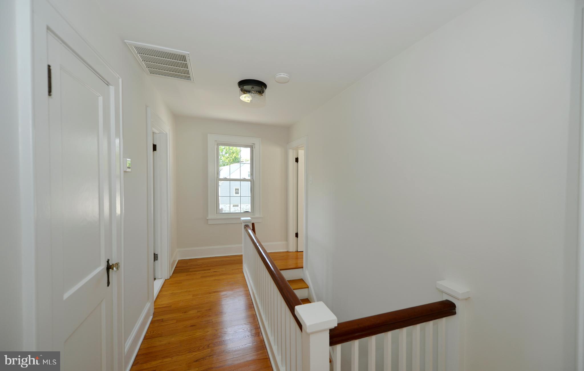 31 West Whitlock Avenue Winchester, VA 22601 - Photo 31 of 37 a view of a hallway with wooden floor and a bathroom