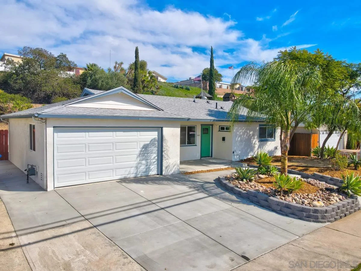 10137 Settle Road Santee, CA 92071 - Photo 3 of 8 a front view of a house with a garden