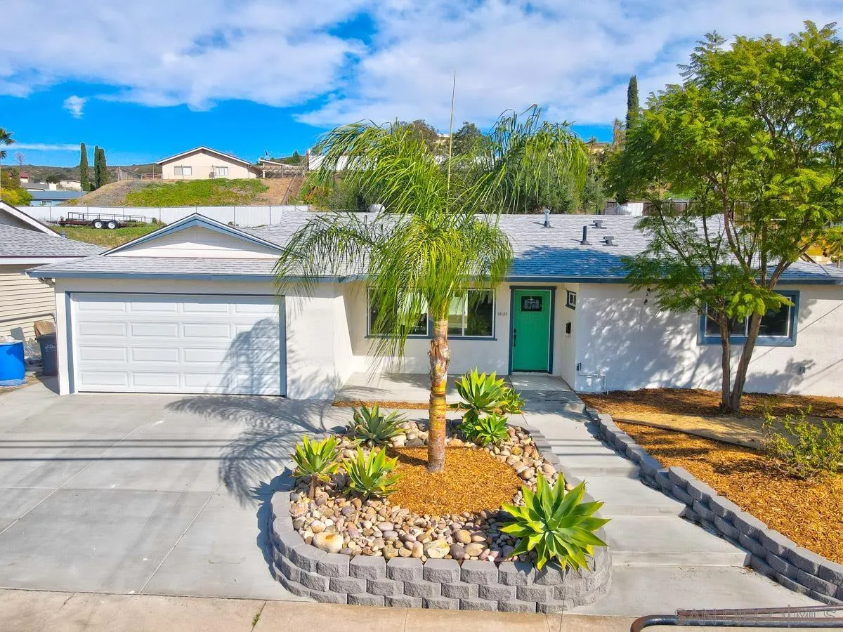 10137 Settle Road Santee, CA 92071 - Photo 4 of 8 a front view of a house with garden