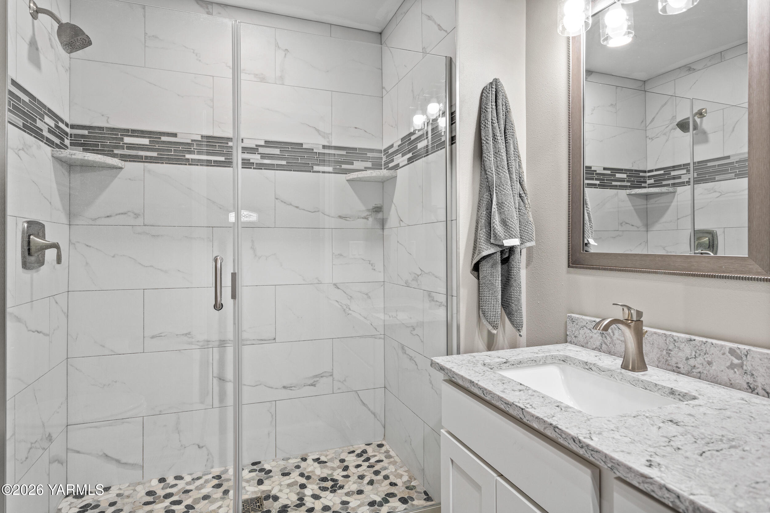 2121 Pleasant Hill Road Selah, WA 98942 - Photo 12 of 38 a bathroom with a granite countertop sink a vanity and a shower