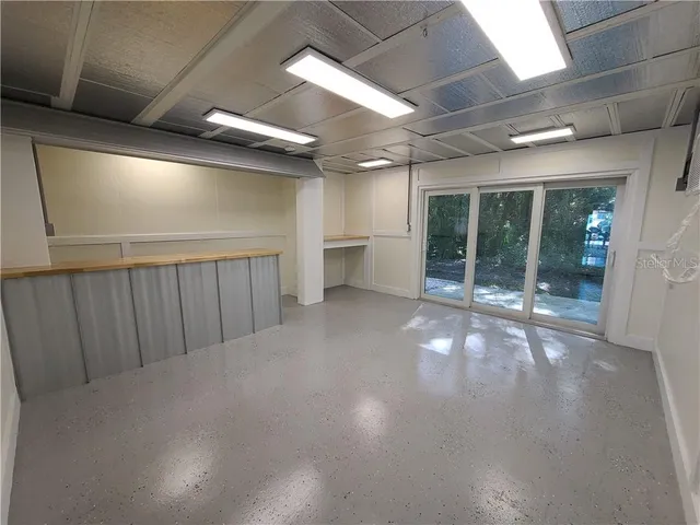 a view of a livingroom with furniture and floor to ceiling window