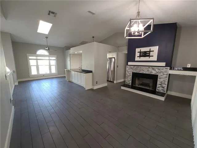a view of living room with furniture and a fireplace