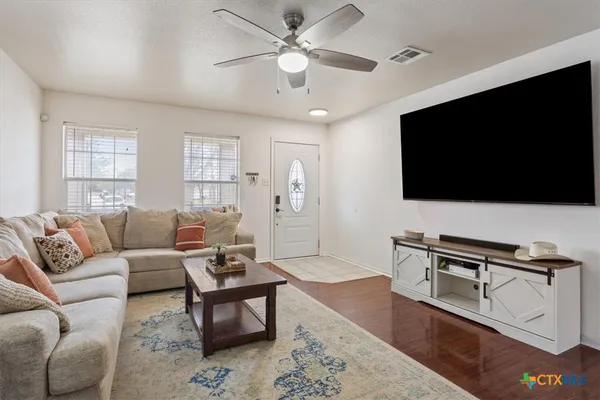 a living room with furniture a fireplace and a window