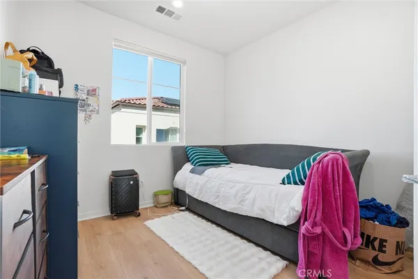 a bedroom with a bed and a window