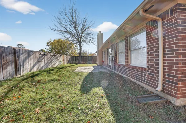 a view of a backyard with a tree