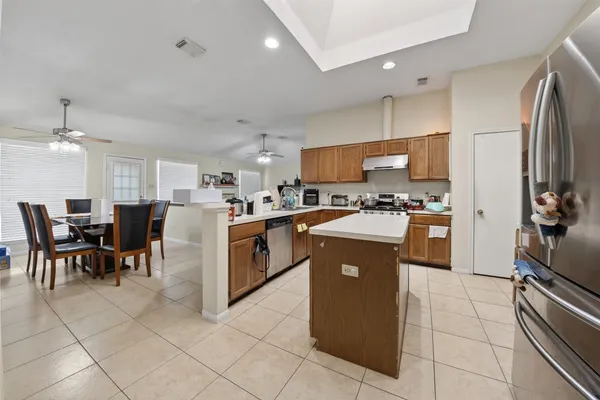 a kitchen with cabinets and chairs