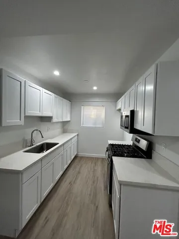 a kitchen that has a sink and a stove