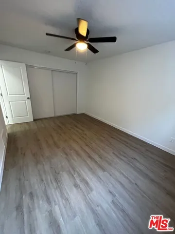 a view of an empty room and wooden floor