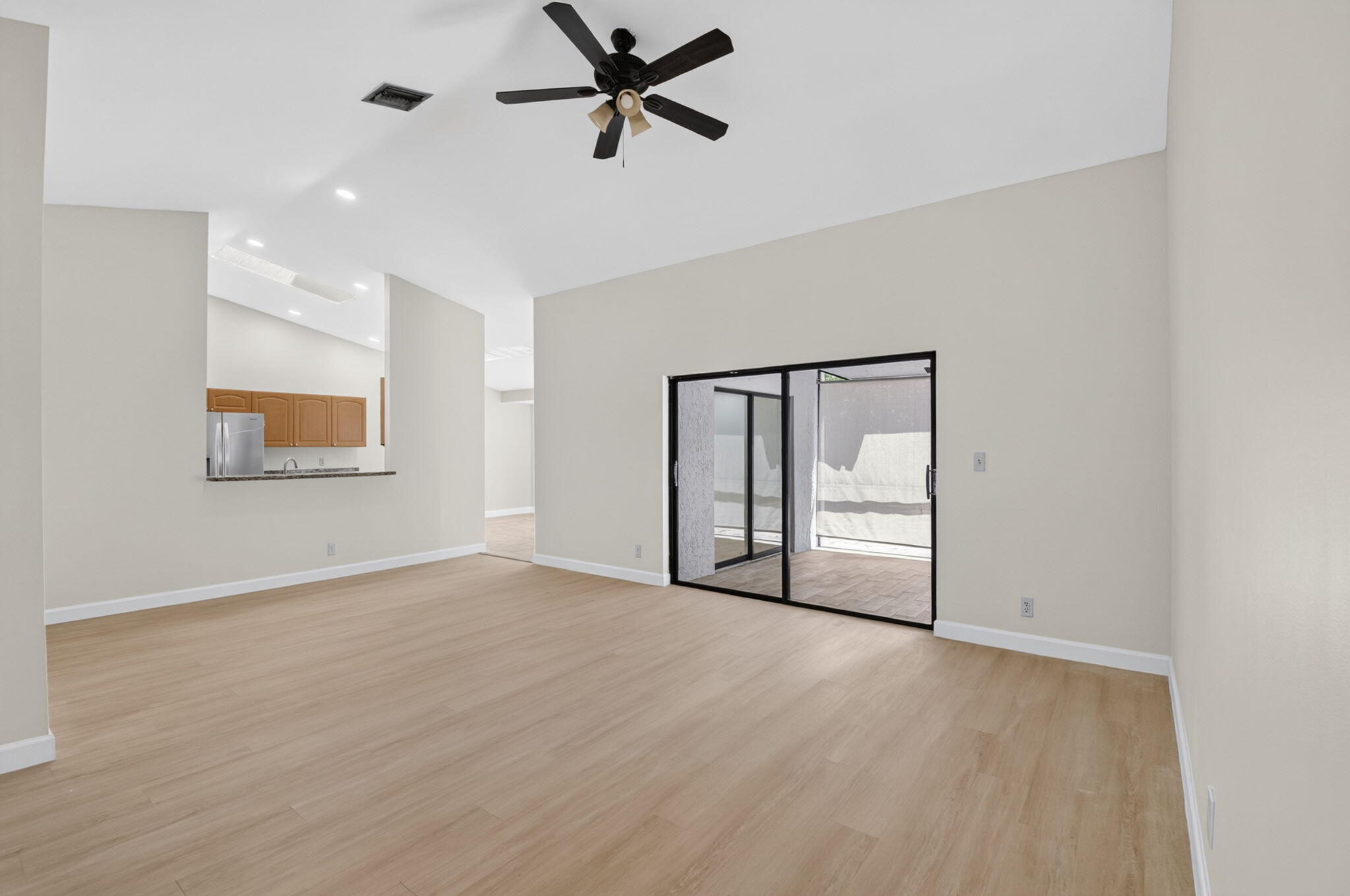 21070 Woodspring Avenue Boca Raton, FL 33428 - Photo 4 of 30 a view of empty room with wooden floor and ceiling fan