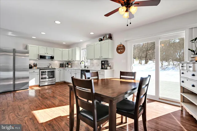 a view of a dining room with furniture and wooden floor