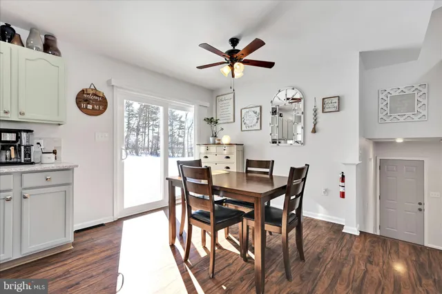 a bathroom with a sink a toilet a mirror and a window