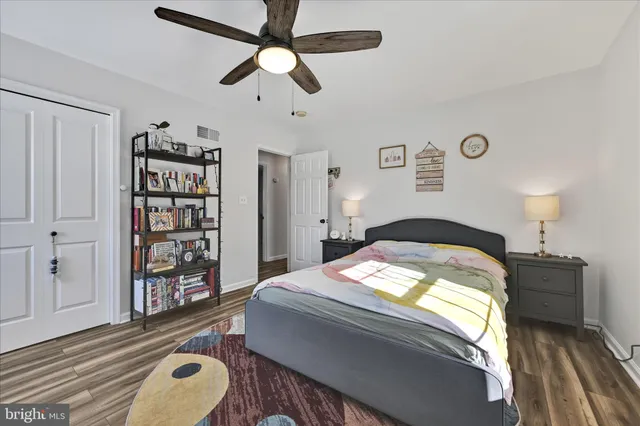 a view of a workspace with furniture and wooden floor