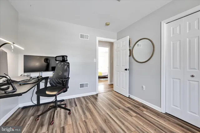 a workspace with furniture hardwood and a window