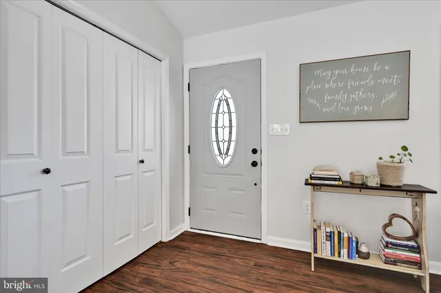 a view of an entryway with wooden floor