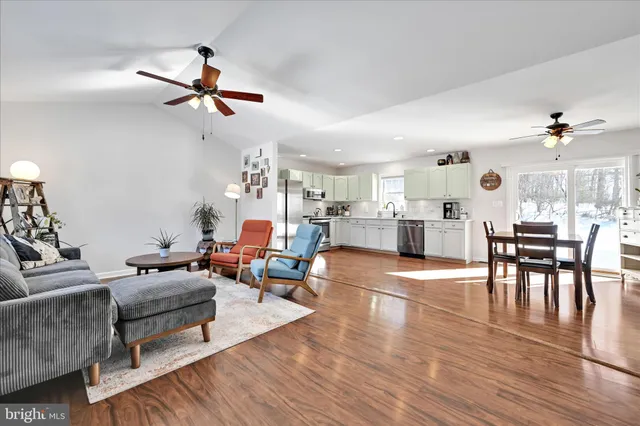 a living room with furniture and kitchen view