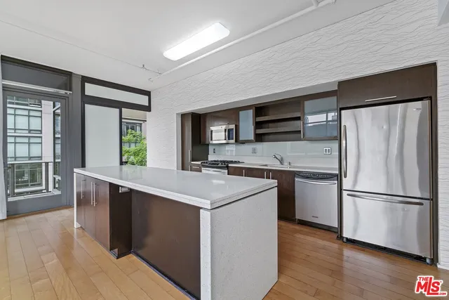 a kitchen with stainless steel appliances a stove a sink and a refrigerator