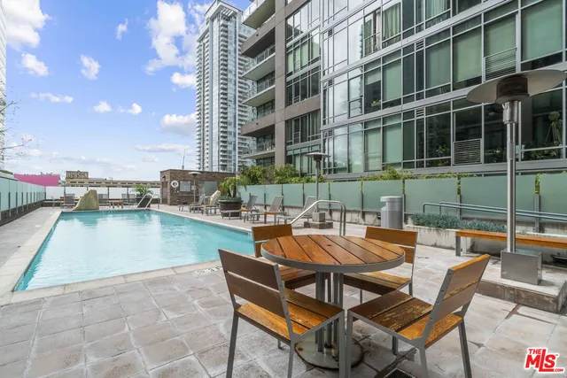 a backyard of a house with barbeque oven table and chairs