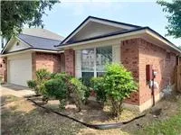 a view of a house with potted plants