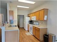 a kitchen with a sink stove top oven and refrigerator