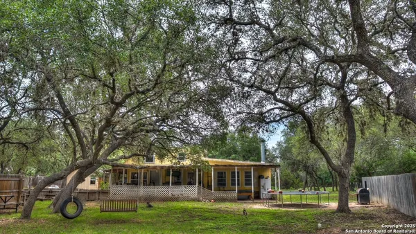 a view of a house with a backyard