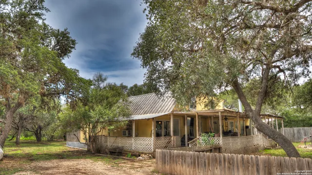 a building outdoor space with patio furniture and potted plants