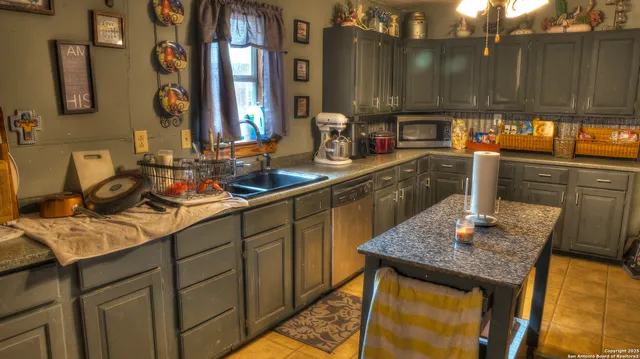a kitchen with sink and a refrigerator