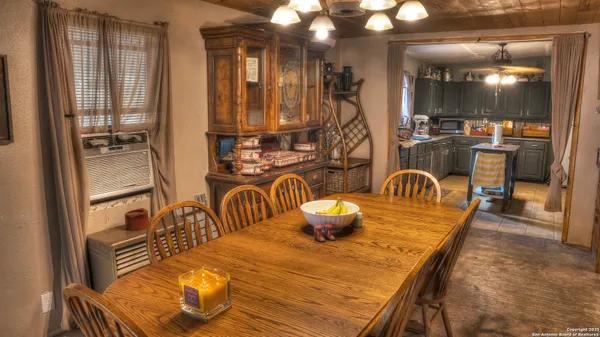 a dining room with furniture and wooden floor