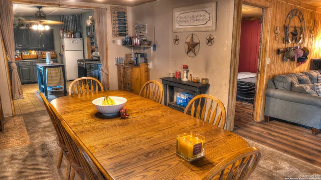a dining room with furniture and wooden floor